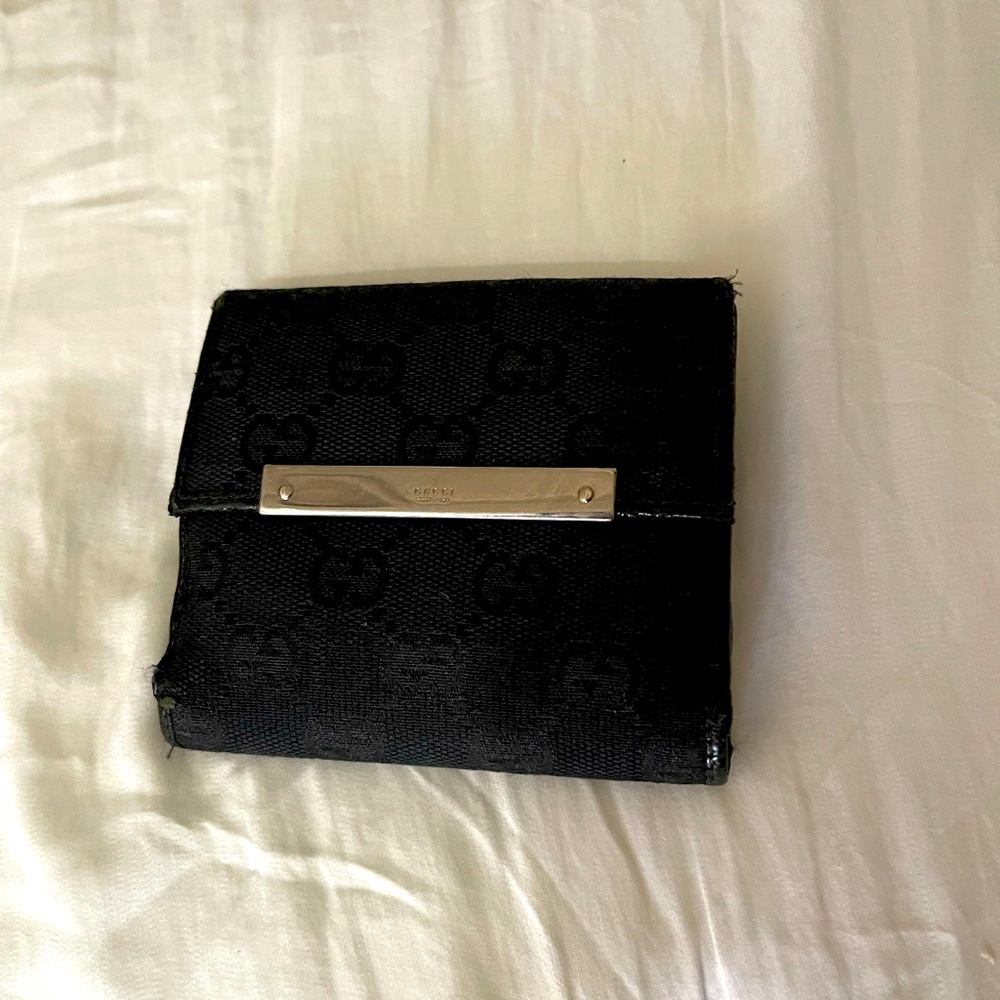 Gucci Wallet black canvas with Gucci monogram.